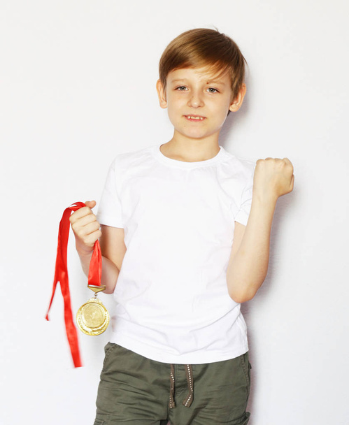 Cute blonde boy with gold medal winner - Foto, Imagen
