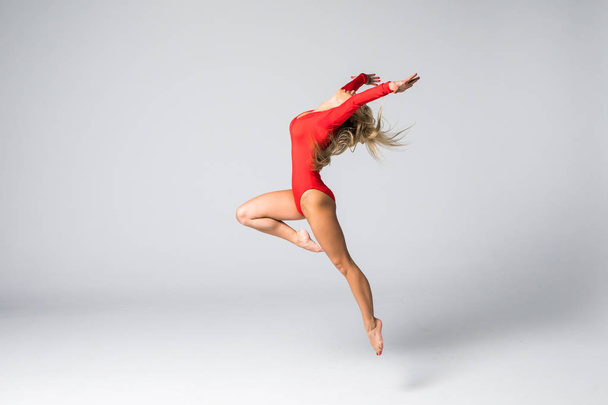 young beautiful dancer gymnastic posing on a studio background - Photo, Image