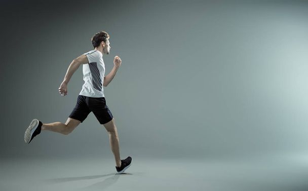 Running, young male athlete - isolated - Zdjęcie, obraz
