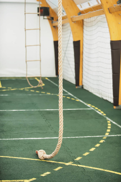 Rope for climbing in sport school gym hall - Фото, изображение