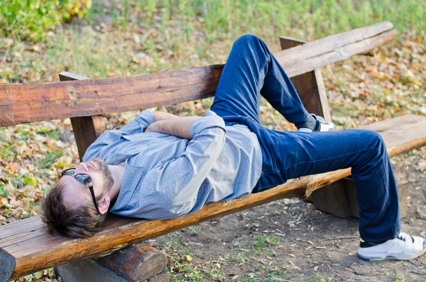 Man relaxing on bench - Фото, зображення