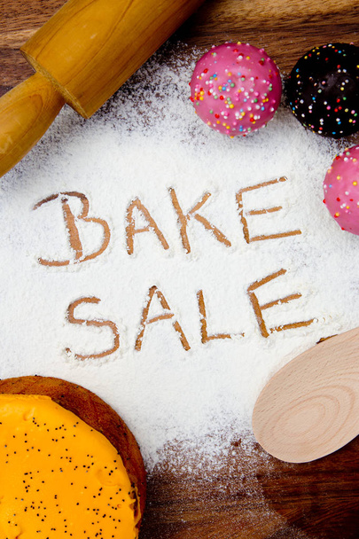 Bake Sale with cake written in flour - Photo, Image