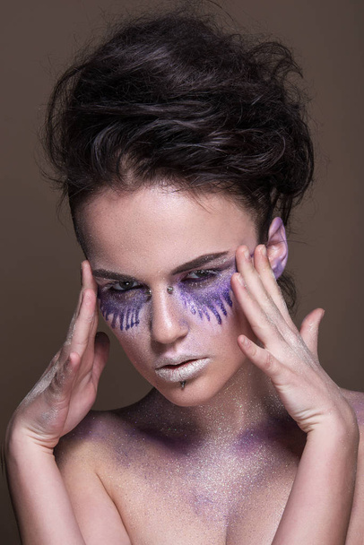 Fashion model with colorful make-up and blue glitter and sparkles on her face and body. - Фото, зображення