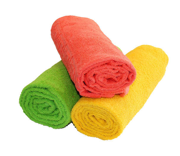 Yellow, green and red rolled up  towels isolated - Photo, Image