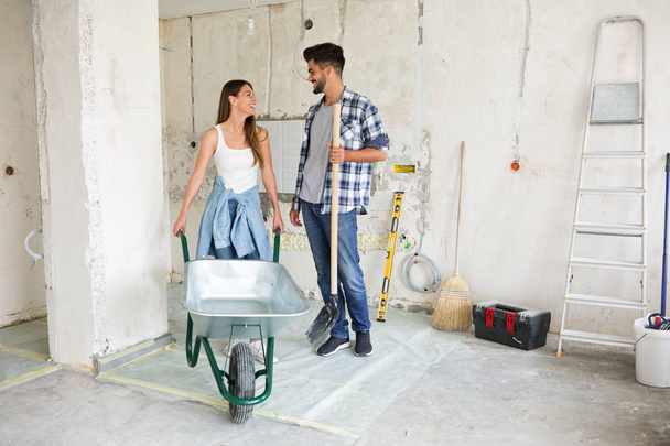 Beautiful young couple renovating their home - 写真・画像