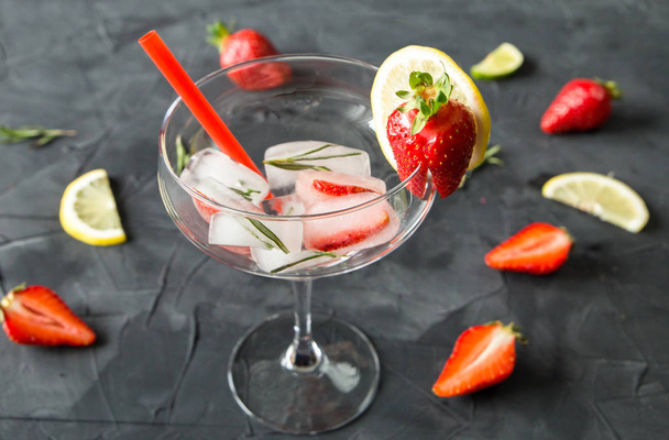 cocktail made from Strawberries and rosemary ice cubes into the glass - Photo, Image