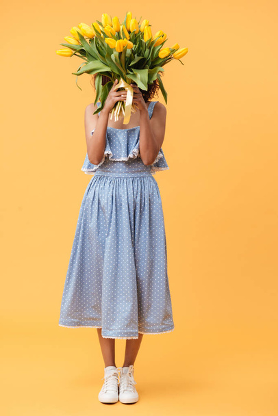 Full-length portrait of african woman hiding behind bouquet flow - Photo, Image