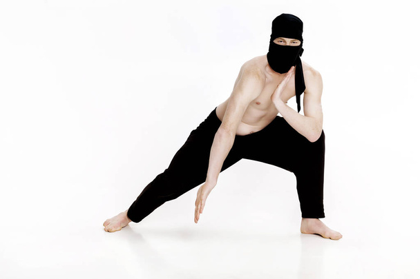 Ninja on white background. Male fighter in black clothes - Photo, Image