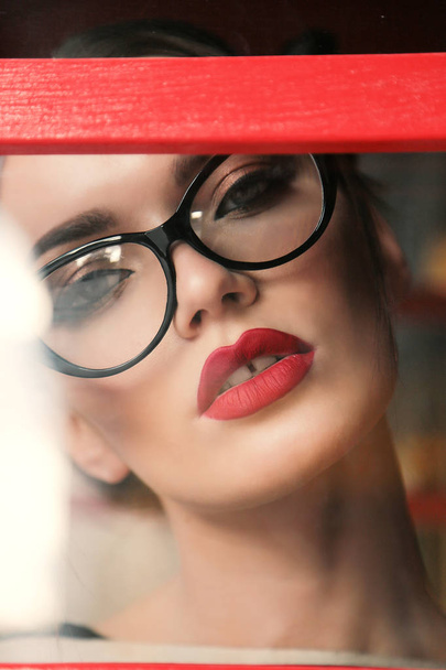 gorgeous young woman with dark hair in casual clothes wears glasses - Zdjęcie, obraz