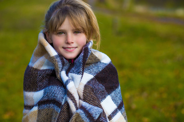 Little Girl in the park in a warm blanket - 写真・画像