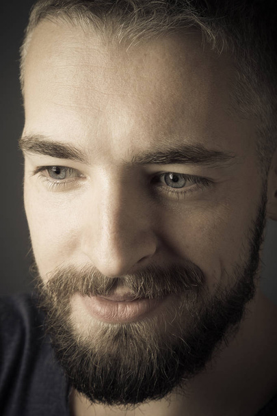 Portrait of a young man with a beard. Toned - Zdjęcie, obraz