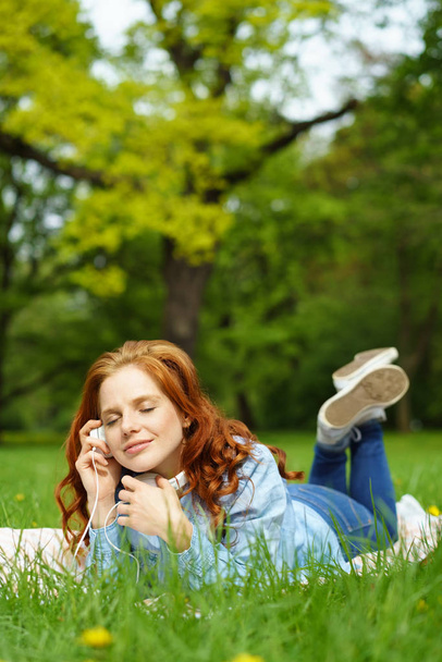 Blissful young woman relaxing with her music - Photo, Image