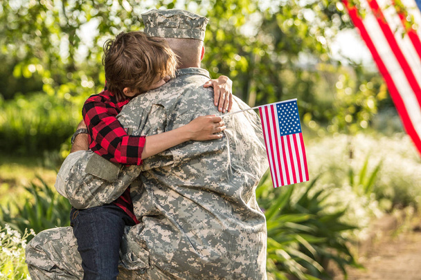American soldier reunited with son on a sunny day  - Фото, изображение