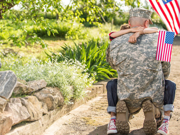 American soldier reunited with son on a sunny day  - Фото, зображення