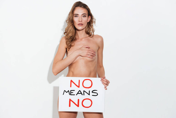 Naked woman holding broadsheet - Fotó, kép