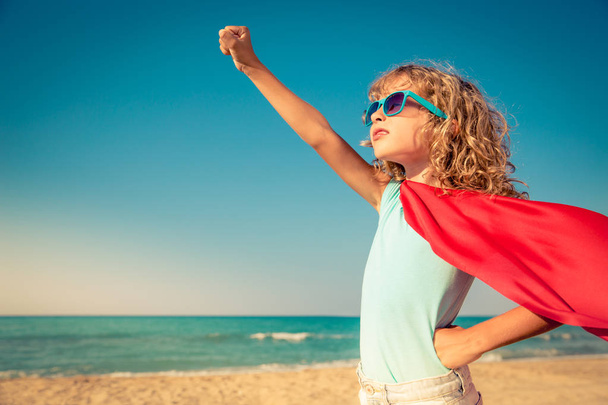 Superhero child on the beach. Summer vacation concept - Фото, зображення