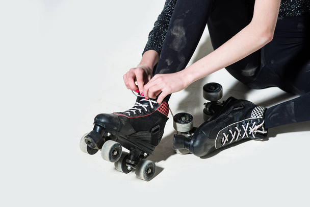 roller skates on woman or girl in black tie laces - Fotoğraf, Görsel