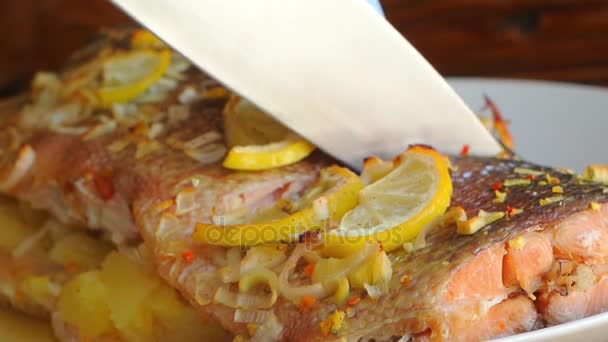 Baked salmon with pineapple and slices of lemon on a plate on a - Footage, Video