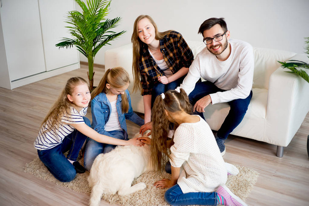 Family playing with a dog - Фото, зображення