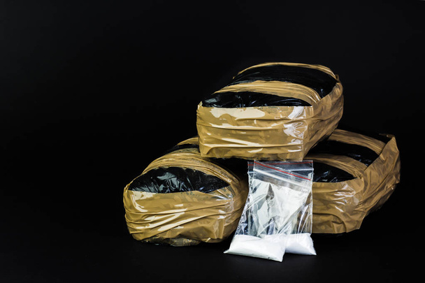 Packages of narcotics isolated on black background. - Photo, Image