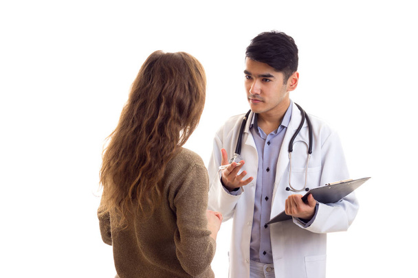 Чоловік лікар розмовляє з молодою жінкою
 - Фото, зображення