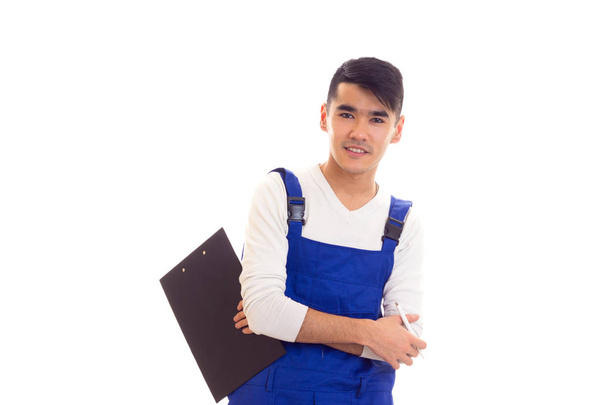 молодой человек в синем с ручкой и папкой в руках - Фото, изображение