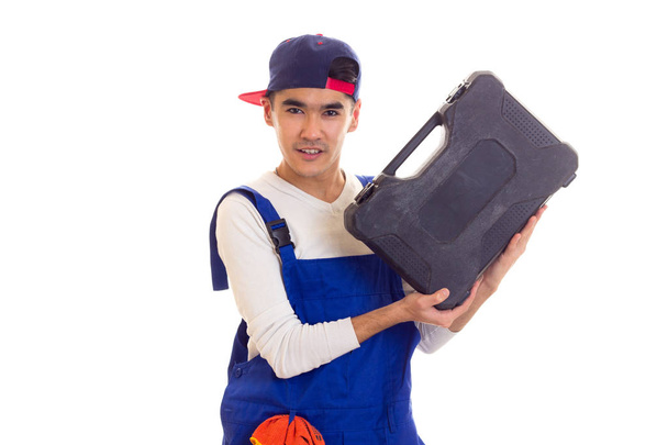 Young man in overall holding toolbox - Photo, Image