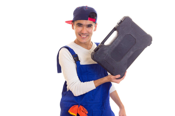 Jonge man in totale bedrijf toolbox - Foto, afbeelding