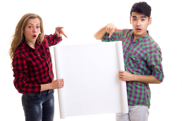 Young couple in plaid shirts holding placard - Foto, Imagem