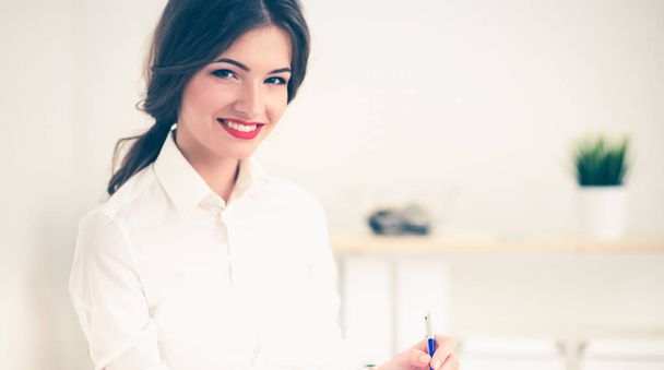 Portrait of a young woman working at office - Foto, Bild