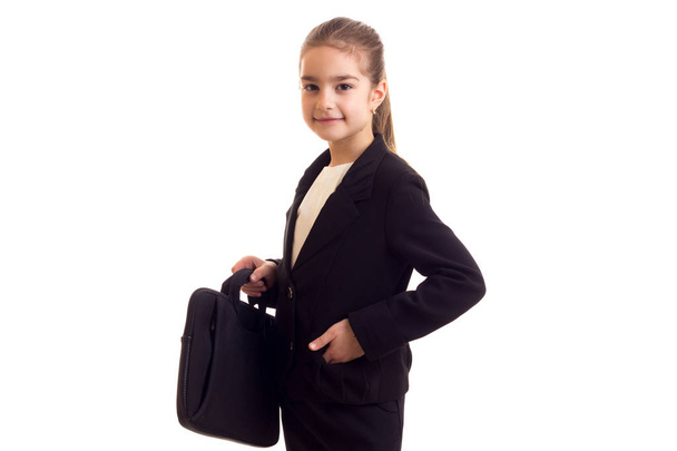 Little girl in black jacket holding diplomat - Foto, Imagen
