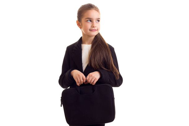 Little girl in black jacket holding diplomat - Photo, Image