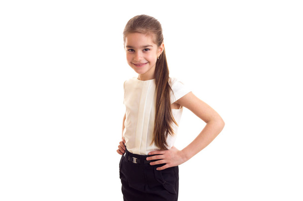 Little girl in white T-shirt and black skirt - Фото, изображение