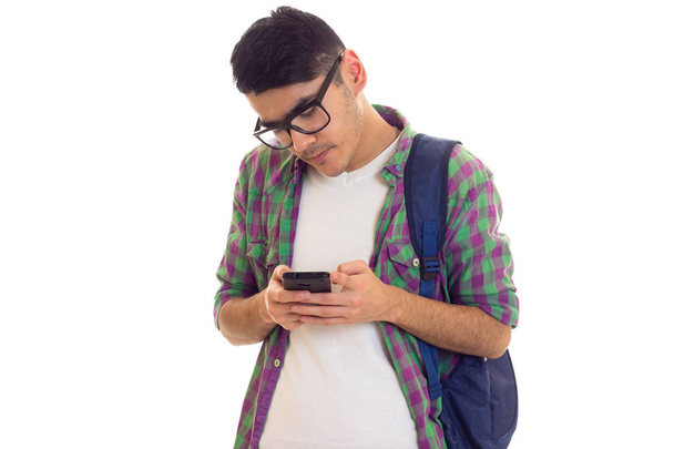 Young man with backpack and smartphone - Photo, Image
