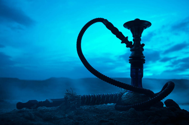 Hookah, traditional arabic waterpipe, direct sunset light, outdoor photo - Photo, Image
