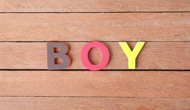 Alphabet letters "BOY" on wood plank. Education concept. - Foto, imagen