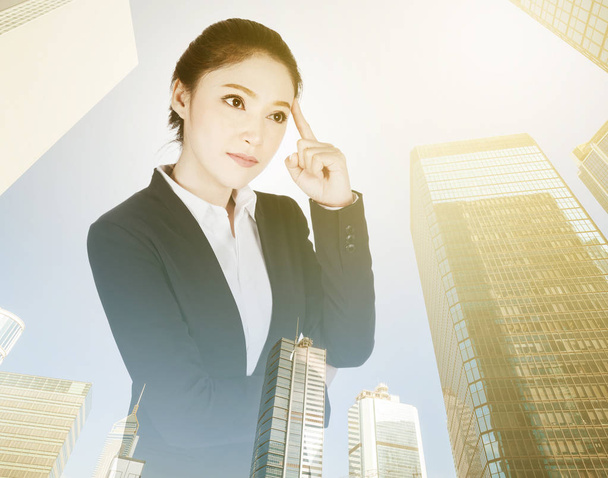 double exposure of  business woman thinking with city background - Fotografie, Obrázek