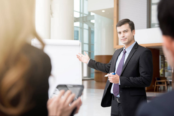 Young businessman as a meeting leader presenting work - Photo, image
