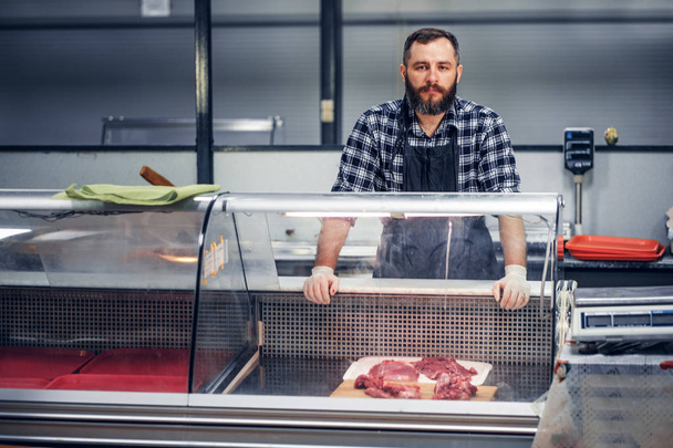 Bearded meat seller serving meat - Photo, Image