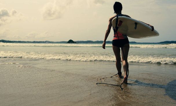 young woman surfer with surfboard  - Фото, зображення