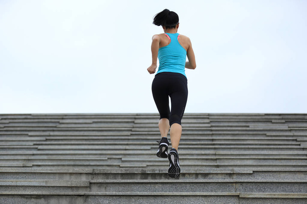 young woman running up on stairs - Foto, Imagen
