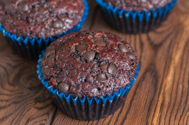 Freshly baked double chocolate muffins on a wooden background wi - Photo, Image