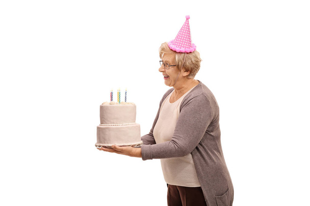 Mature woman holding a birthday cake - Zdjęcie, obraz