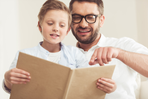 son with father reading book - Photo, Image