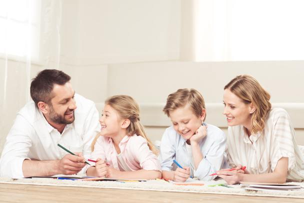 happy family drawing pictures at home - 写真・画像