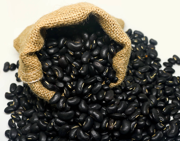 black beans in hemp sack bag on white background. - Photo, Image