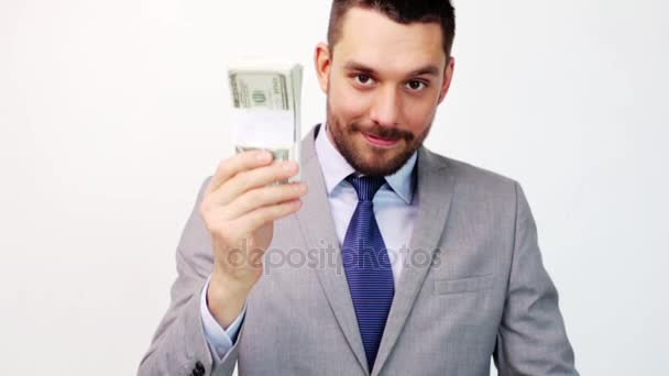 happy businessman with packets of dollar money - Imágenes, Vídeo