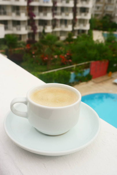 Cup of  coffee  on the background of the pool - Zdjęcie, obraz