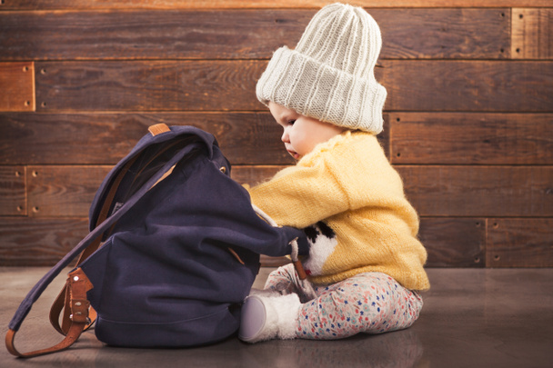 Cute baby with backpack on wooden background - Φωτογραφία, εικόνα