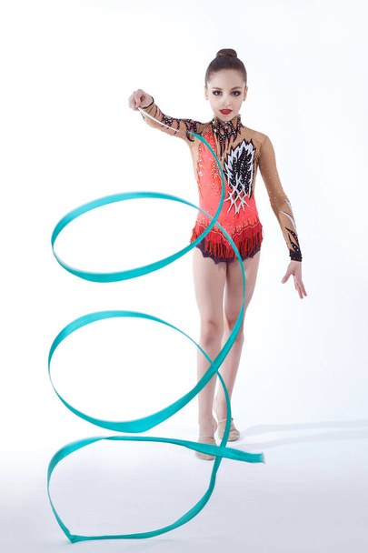 beautiful caucasian girl gymnast with Turquoise ribbon - Photo, image